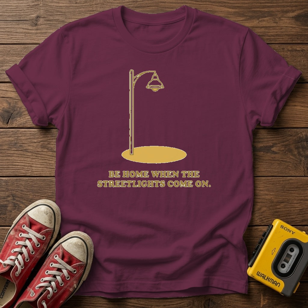 “Be Home When the Streetlights Come On”  T‑Shirt — Heather Maroon wood flat-lay