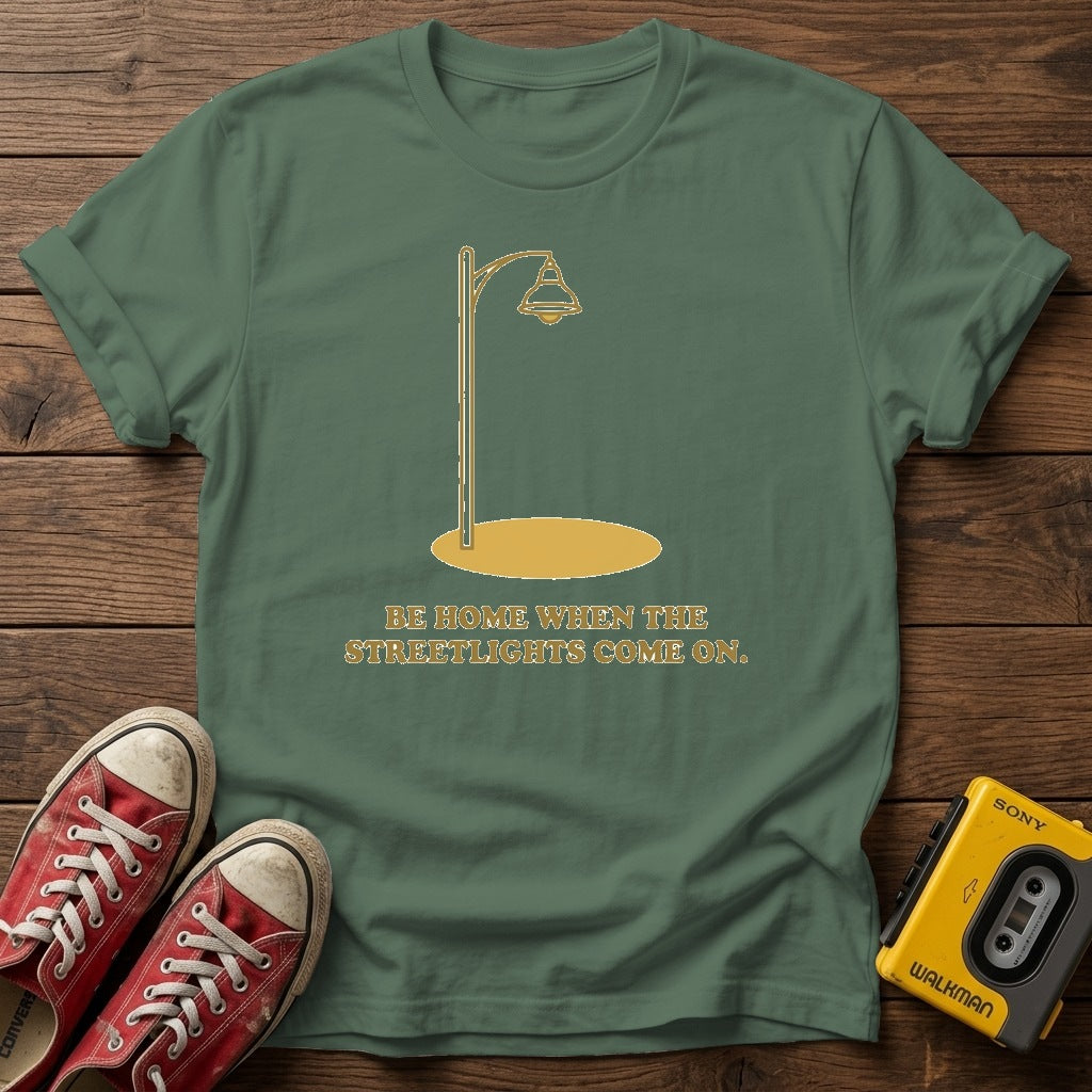 “Be Home When the Streetlights Come On”  T‑Shirt — Military Green wood flat-lay