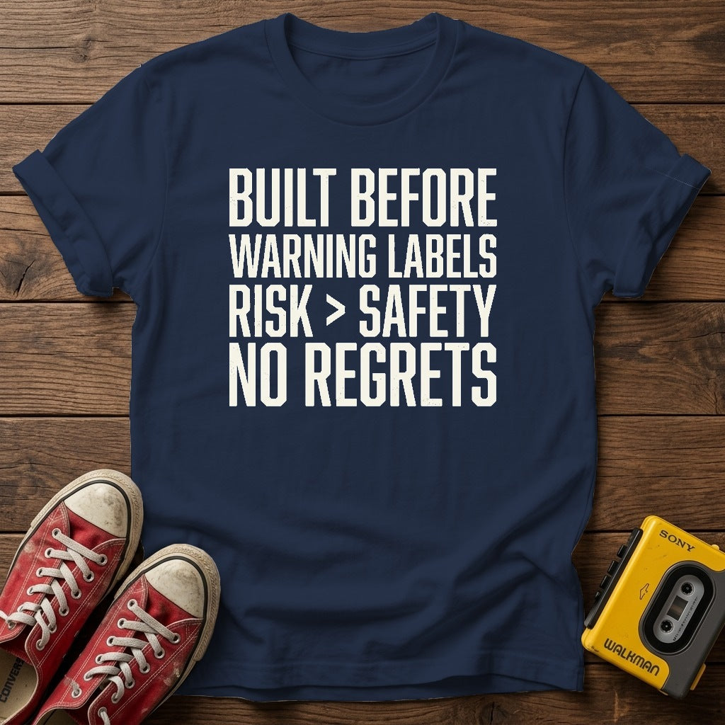 “Built Before Warnings Labels Risk + Safety No Regrets” Graphic T-Shirt — Navy wood flat-lay