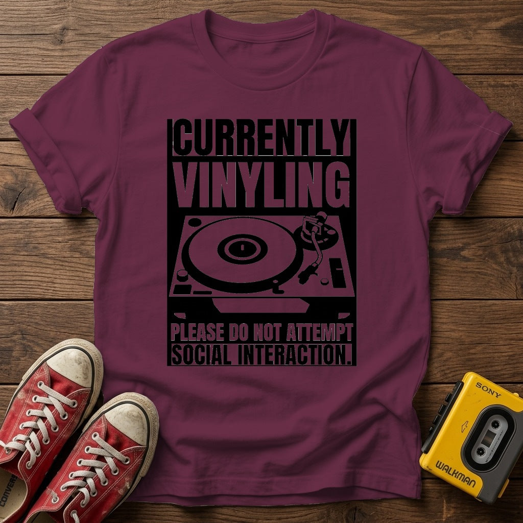"Currently Vinyling, Please Do Not Attempt Social Interaction" T-Shirt — Heather Maroon wood flat-lay