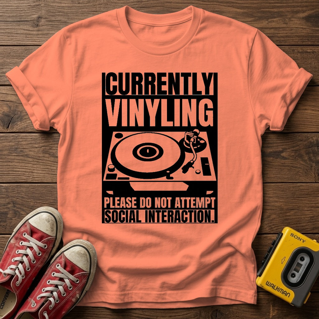 "Currently Vinyling, Please Do Not Attempt Social Interaction" T-Shirt — Heather Orange wood flat-lay