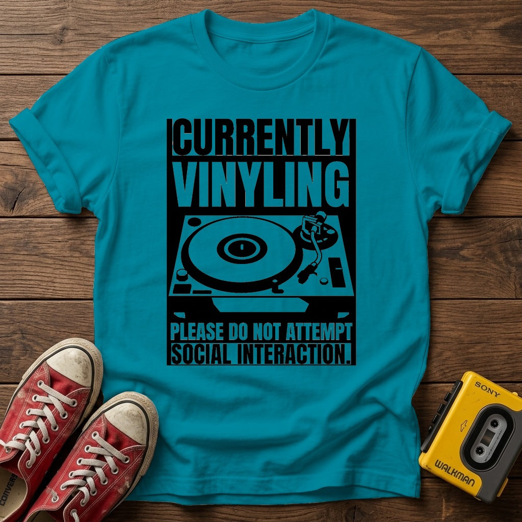 "Currently Vinyling, Please Do Not Attempt Social Interaction" T-Shirt — Tropical Blue wood flat-lay