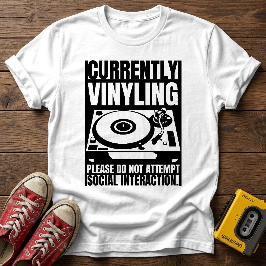 "Currently Vinyling, Please Do Not Attempt Social Interaction" T-Shirt — White wood flat-lay