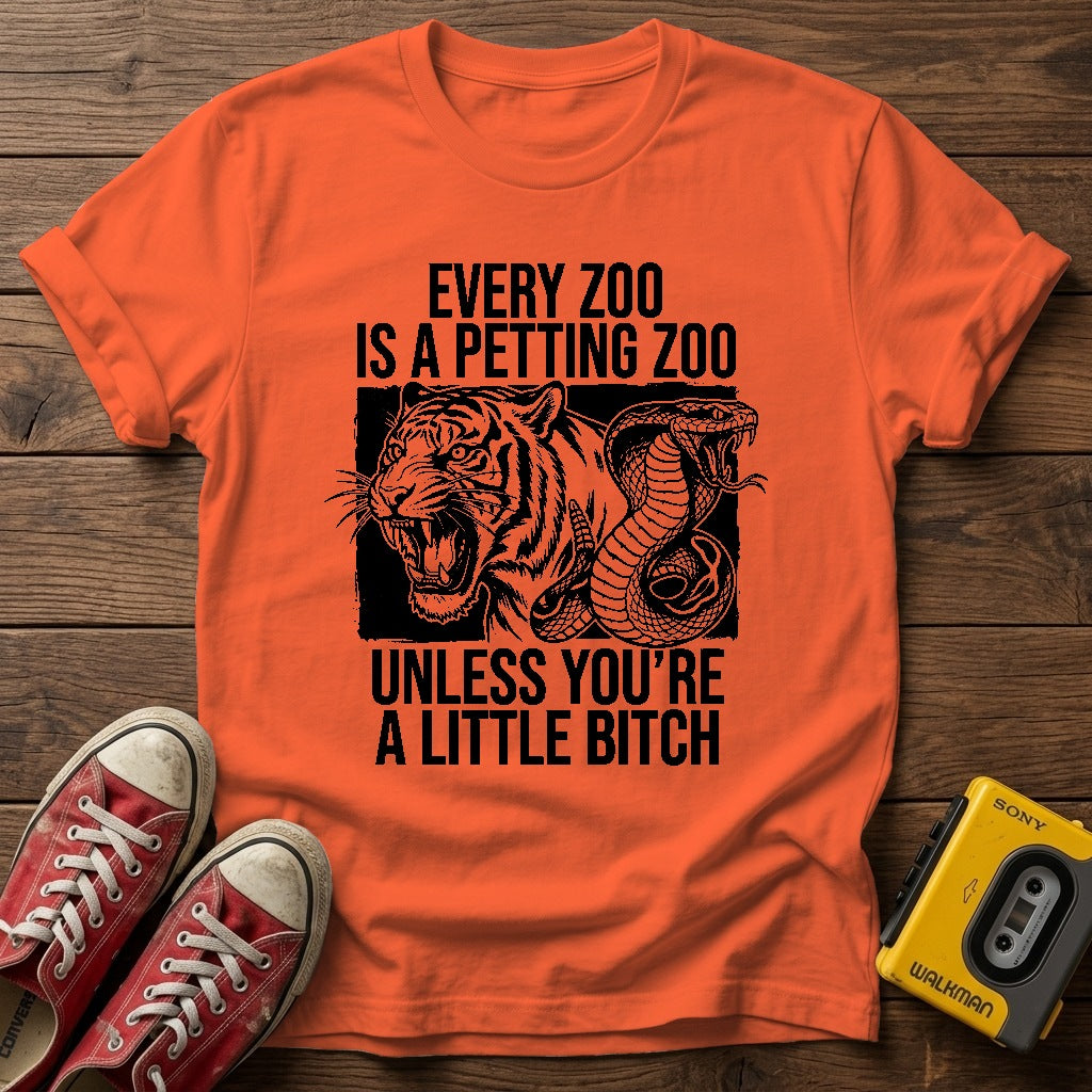 Every Zoo Is a Petting Zoo Unless You’re a Little Bitch T-Shirt — Orange wood flat-lay