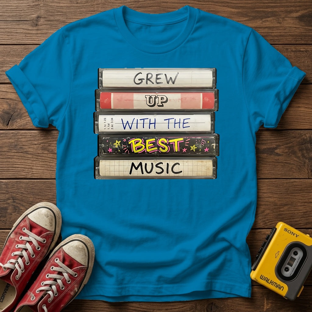 "Grew Up With The Best Music" Vintage Cassette Stack T Shirt — Heather Sapphire wood flat-lay
