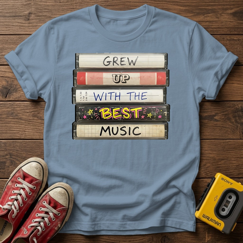 "Grew Up With The Best Music" Vintage Cassette Stack T Shirt — Stone Blue wood flat-lay