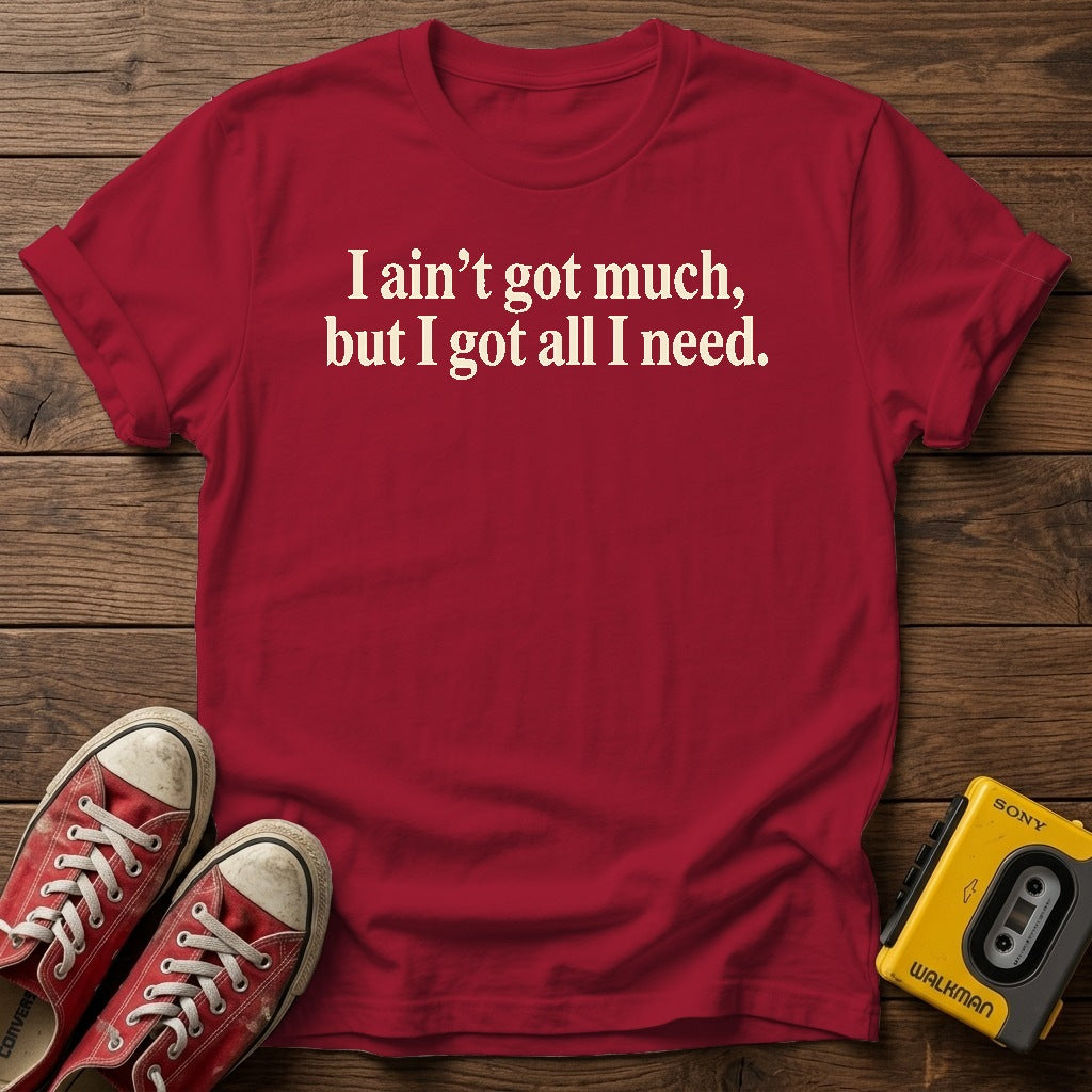 I ain’t got much, but I got all I need T-Shirt — Antique Cherry Red wood flat-lay