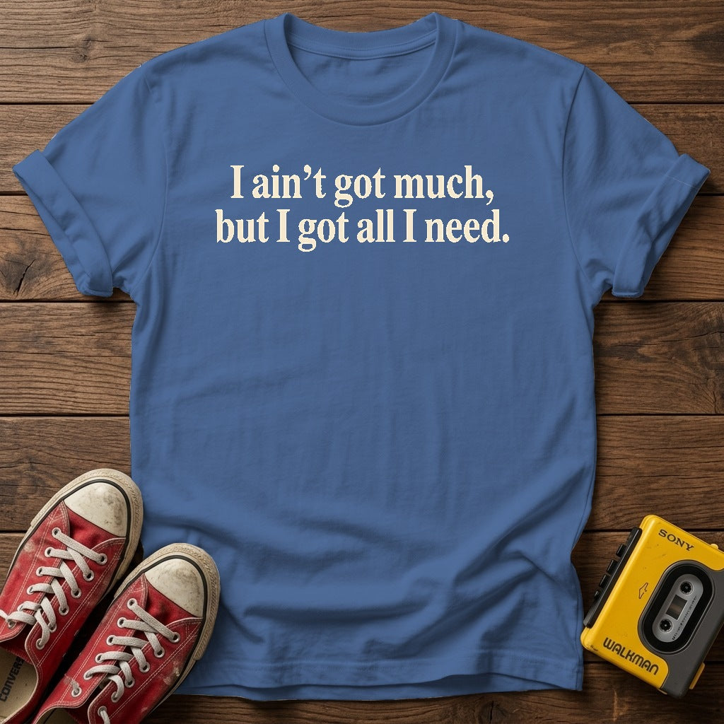 I ain’t got much, but I got all I need T-Shirt — Heather Indigo wood flat-lay