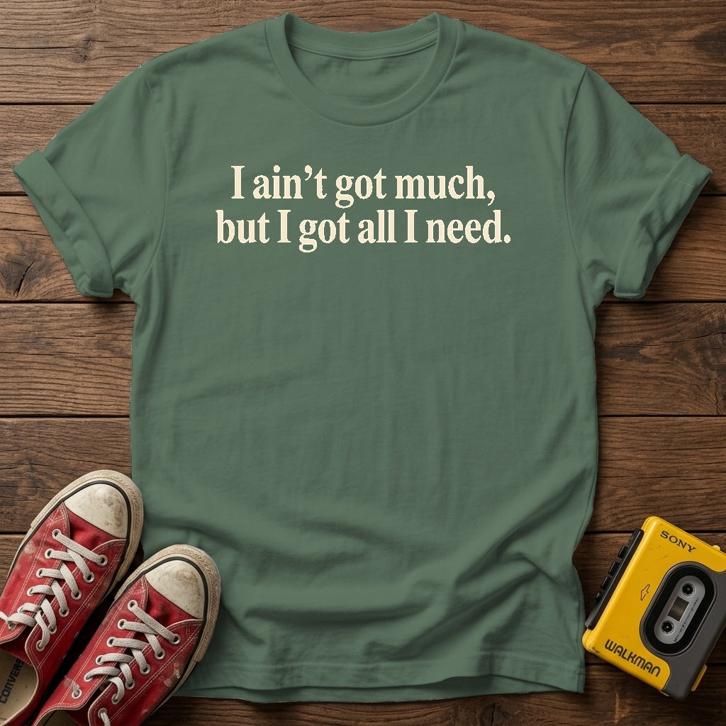 I ain’t got much, but I got all I need T-Shirt — Military Green wood flat-lay