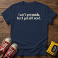 I ain’t got much, but I got all I need T-Shirt — Navy wood flat-lay