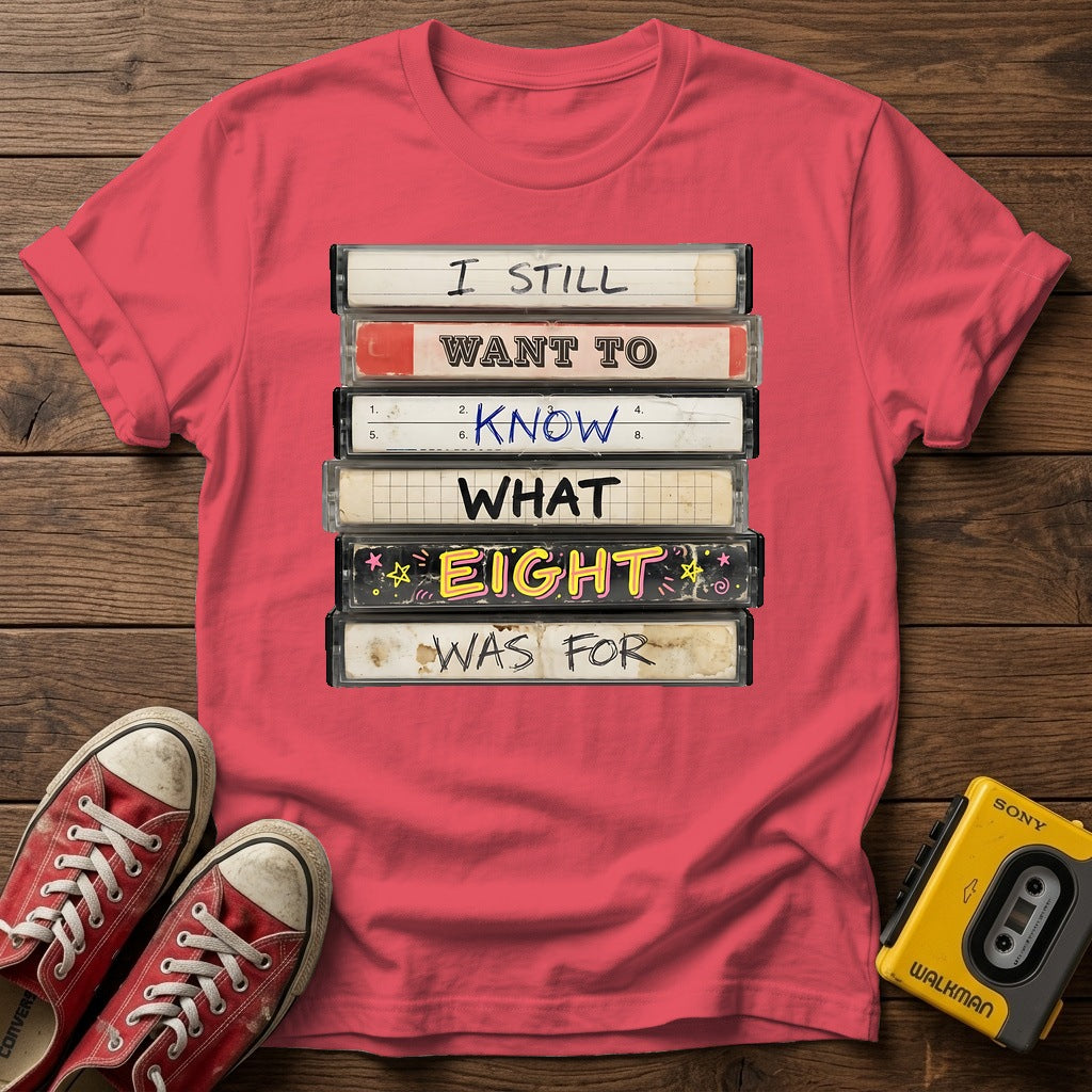 “I Still Want To Know What Eight Was For” Retro VHS Stack T Shirt — Heather Red wood flat-lay