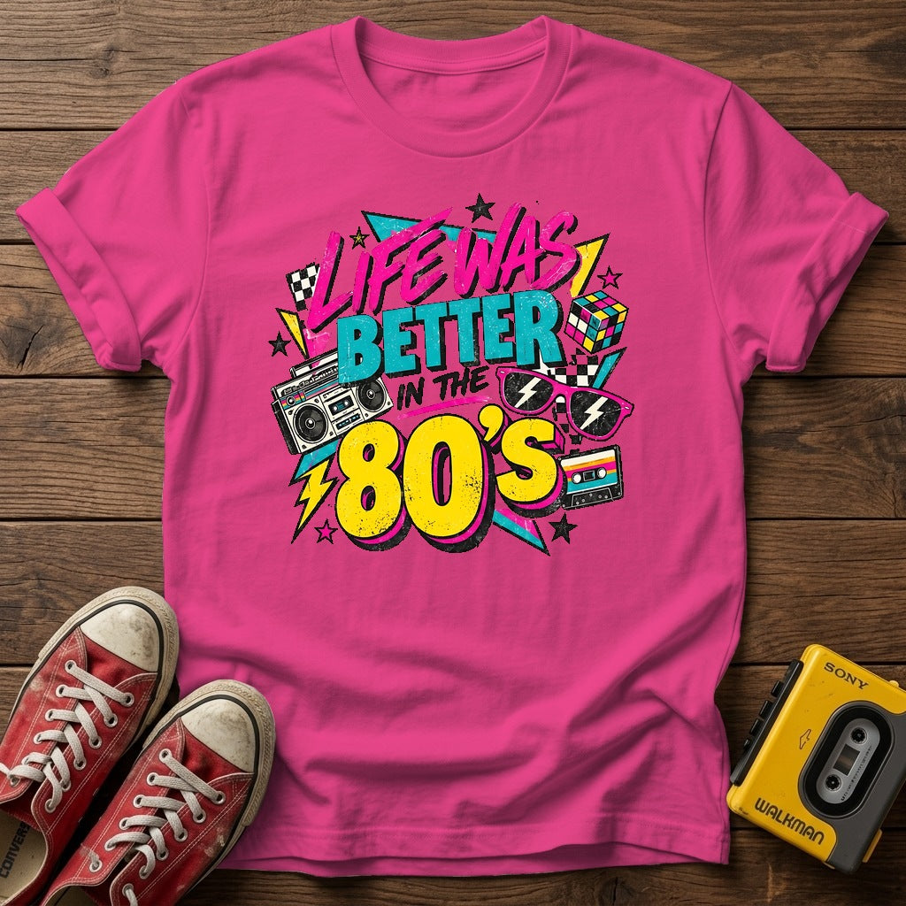 Life Was Better in the 80s T-Shirt — Heather Heliconia wood flat-lay