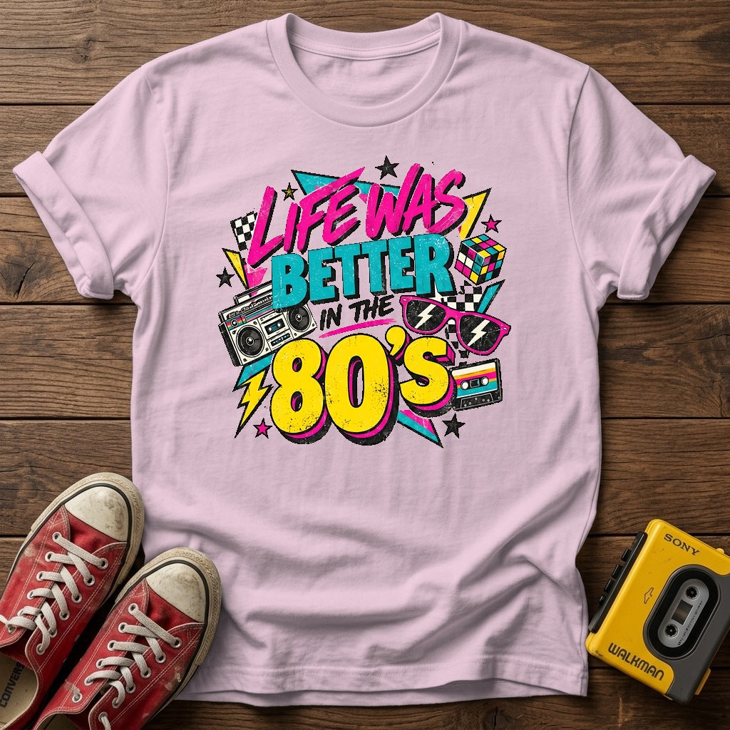 Life Was Better in the 80s T-Shirt — Light Pink wood flat-lay
