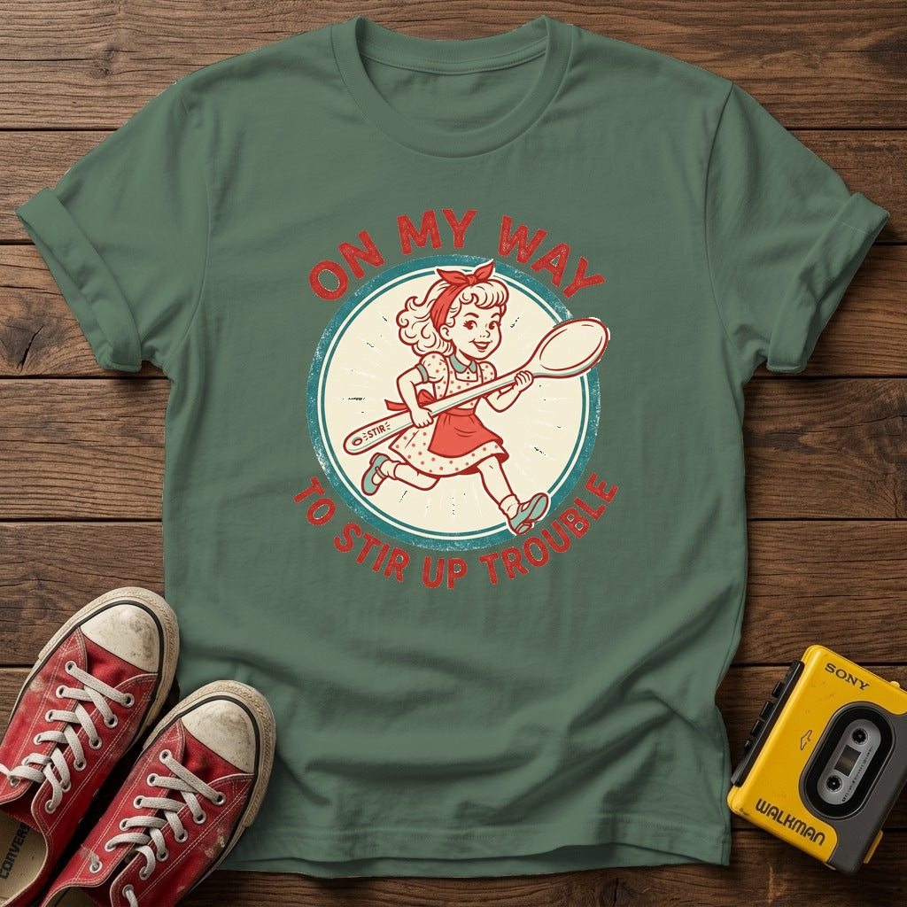 "On My Way to Stir Up Trouble" T-Shirt — Military Green wood flat-lay