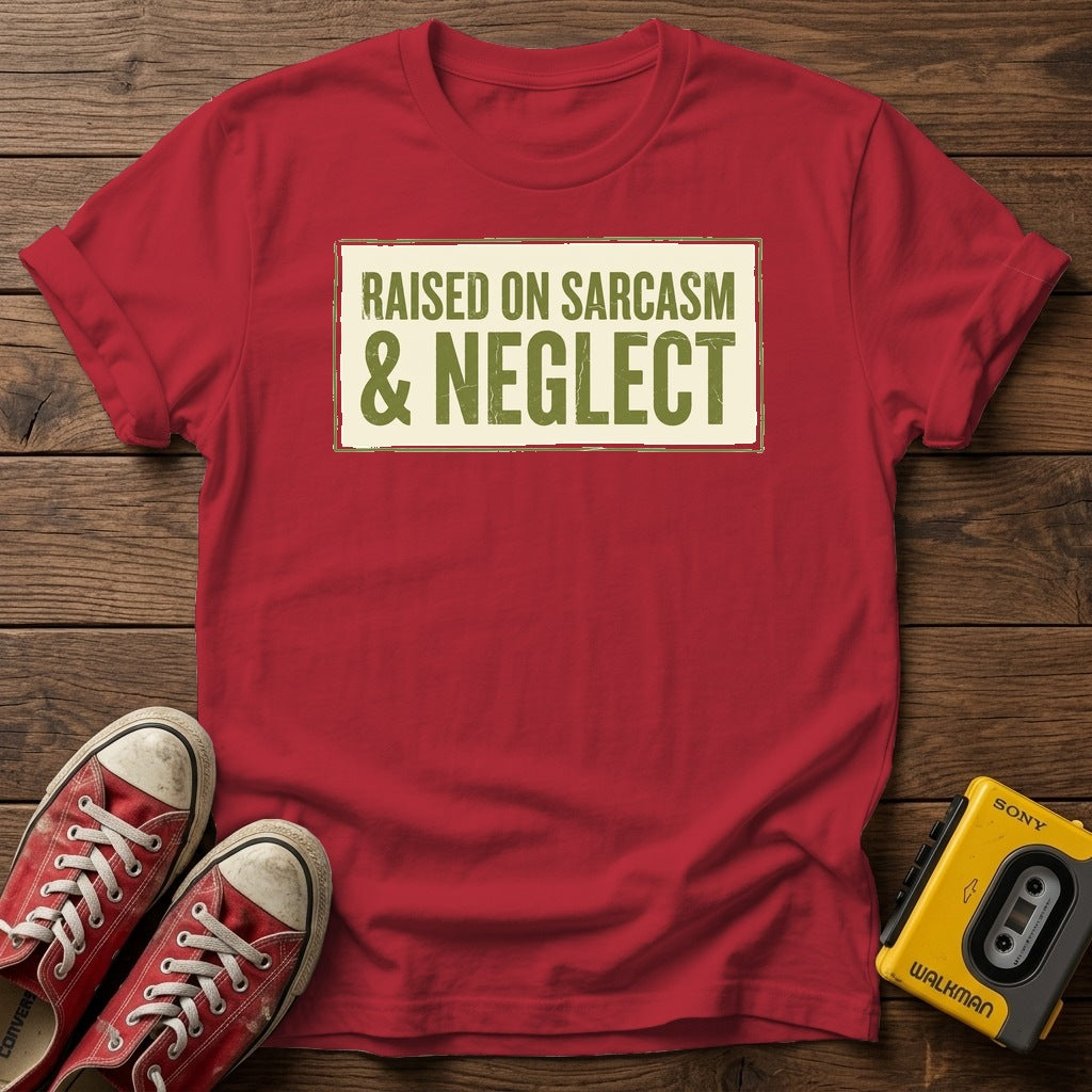 Raised on Sarcasm & Neglect T-Shirt — Cherry Red wood flat-lay