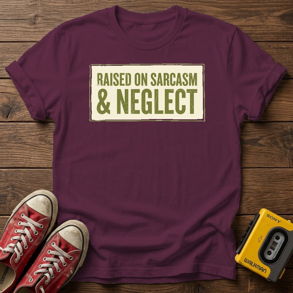 Raised on Sarcasm & Neglect T-Shirt — Maroon wood flat-lay