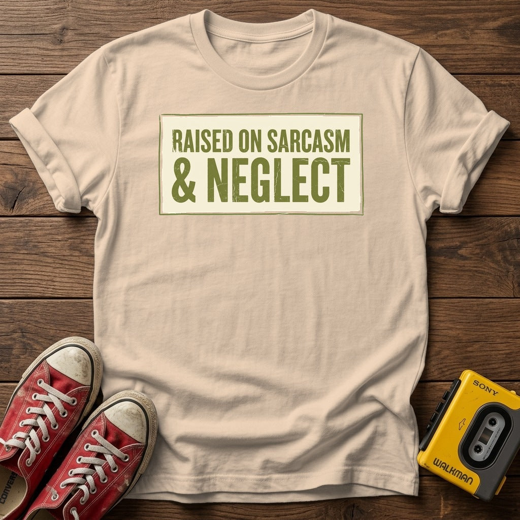 Raised on Sarcasm & Neglect T-Shirt — Natural wood flat-lay