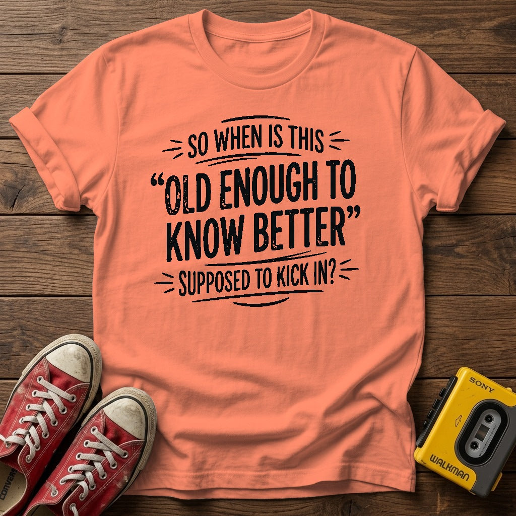 "So When Is This 'Old Enough to Know Better' Supposed to Kick In?" T Shirt — Heather Orange wood flat-lay