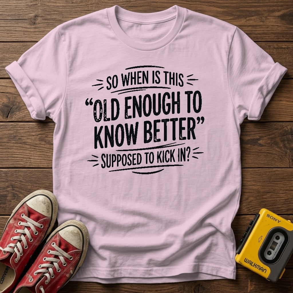 "So When Is This 'Old Enough to Know Better' Supposed to Kick In?" T Shirt — Light Pink wood flat-lay